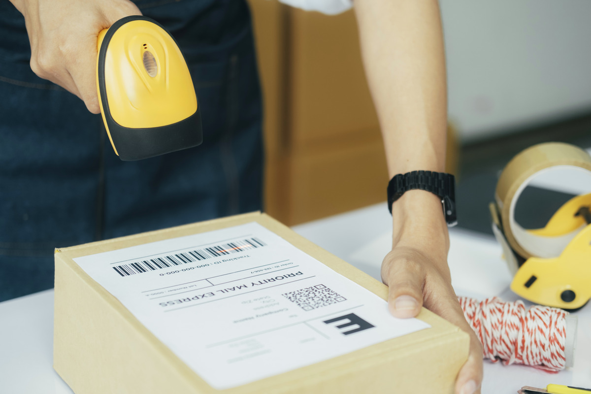 female-seller-worker-online-store-holding-scanner-scanning-parcel-barcode-tag-packing-ecommerce-post-shipping-box-checking-online-retail-store-orders-dropshipping-delivery-service-warehouse-1